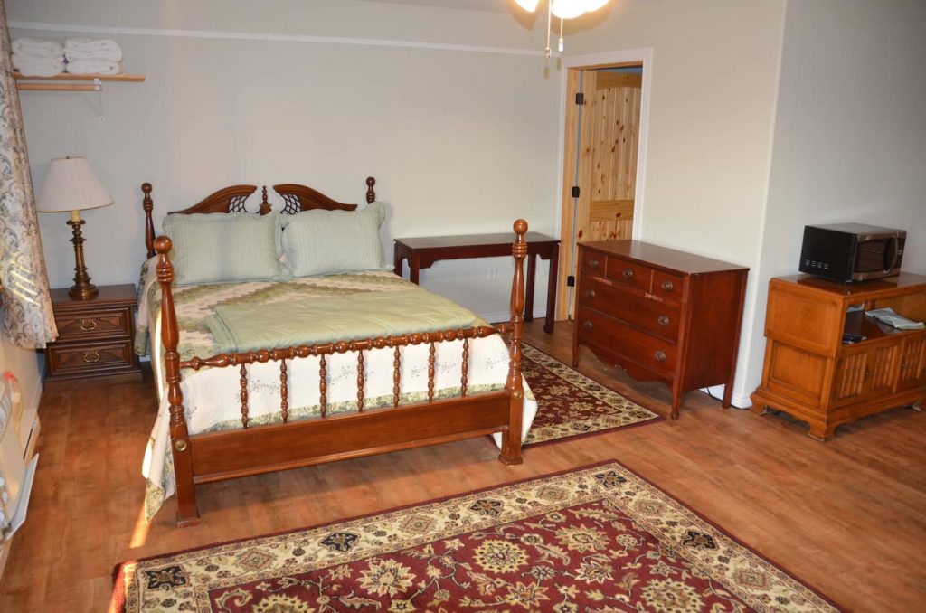 Lake Fork Farm | Queen Bed.Fully equipped kitchen and dining area with large sleeper sofa in the living area